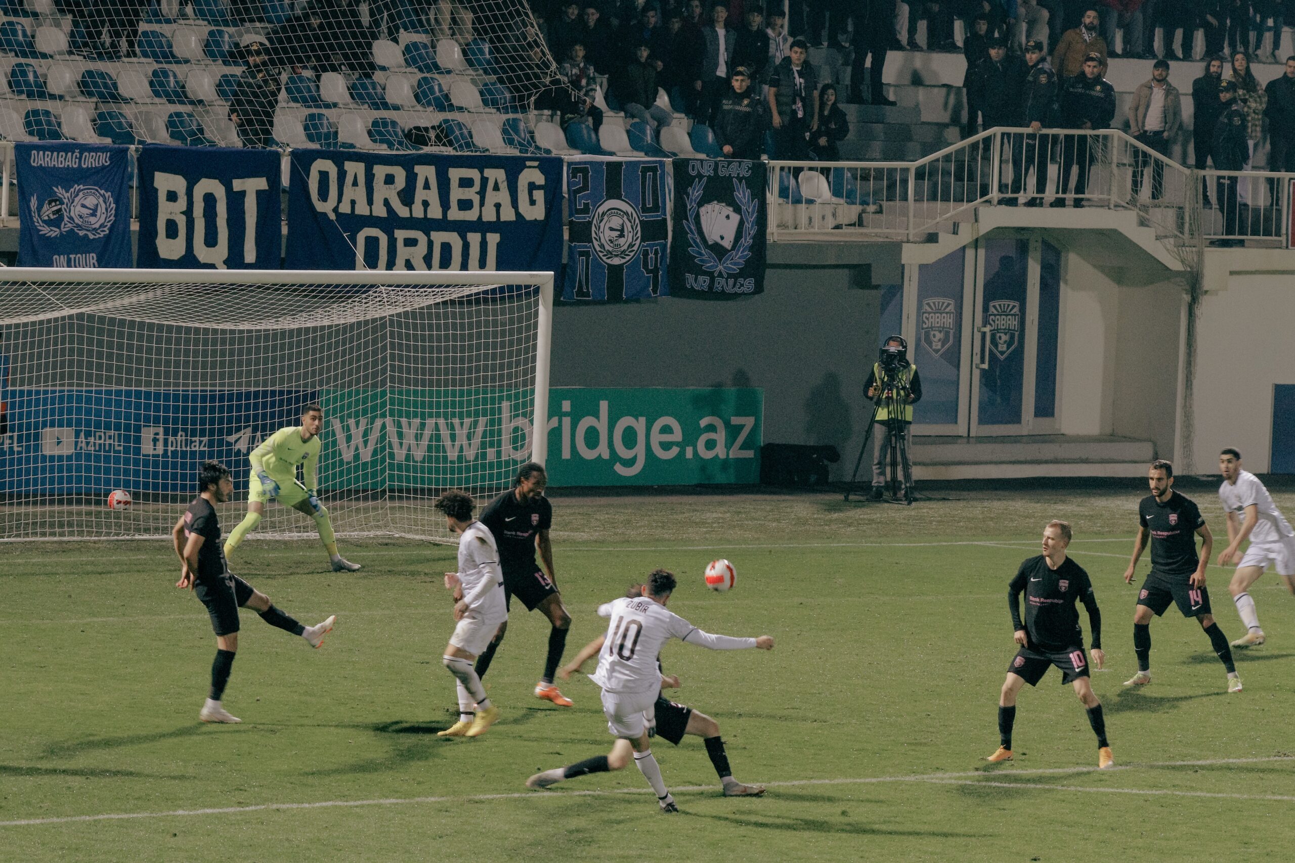 man kicking a football in a stadium